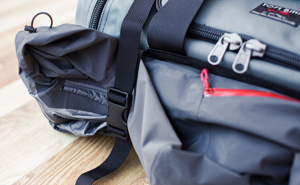 The Road Buddy Lash Straps holding a jacket on a Road Buddy Duffel 60.